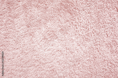 Light pink towel texture background. Fluffy pile fabric backdrop.