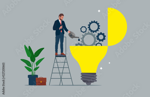 Businessman drop lubricant or grease into open lightbulb lamp with mechanical gears. Maintenance to generate idea or creativity and innovation.