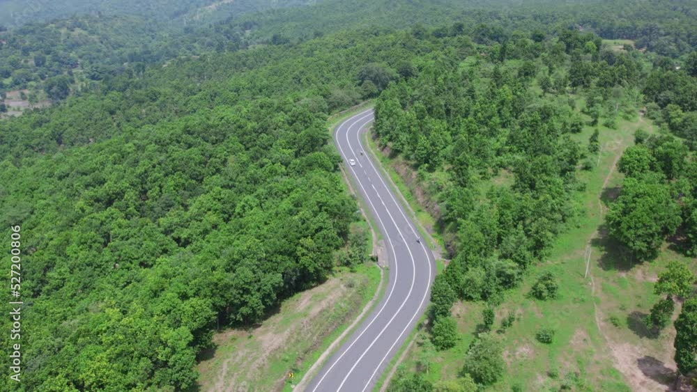 Aerial view of road going through greenery, Roads through the green forest, drone landscape Aerial view of road going through greenery, Roads through the green forest, drone landscape