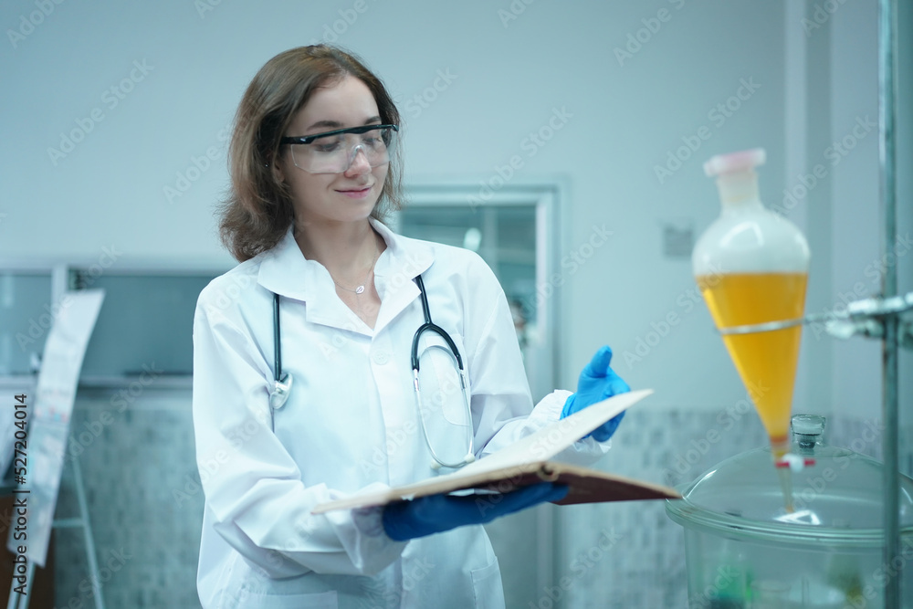Young scientist in white lab coat working with binocular microscope in the material science lab Young scientist in white lab coat working with binocular microscope in the material science lab