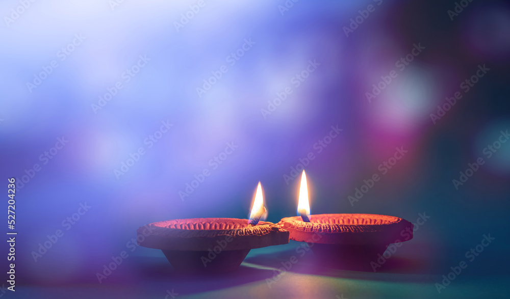 Diwali, Deepavali Hindu festival of lights. Diya lamp lit on blue background