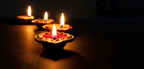 Diwali, Deepavali Hindu festival of lights. Diya lamp lit on black, close up