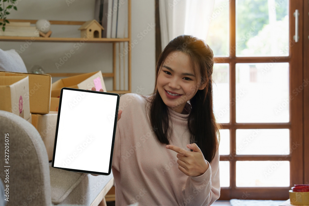 Asian SME business woman showing tablet empty screen at home office. Marketing time banner template Asian SME business woman showing tablet empty screen at home office. Marketing time banner template