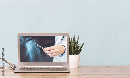 Stethoscope on a laptop. Virus season, pandemic. Remote medicine or elearning and telemedicine and consultation advice. Copy space. Medical network . Doctor hand with xray imaging on screen banner photo
