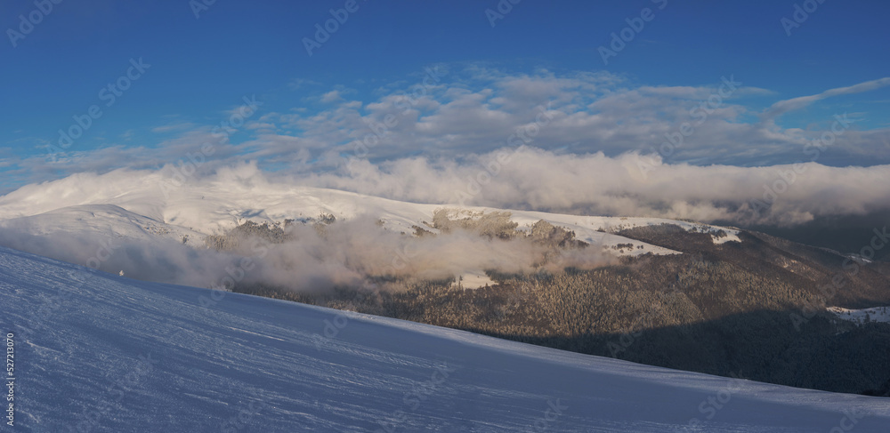 Mountain range covered with snow. Winter landscape. Panorama from several shots.