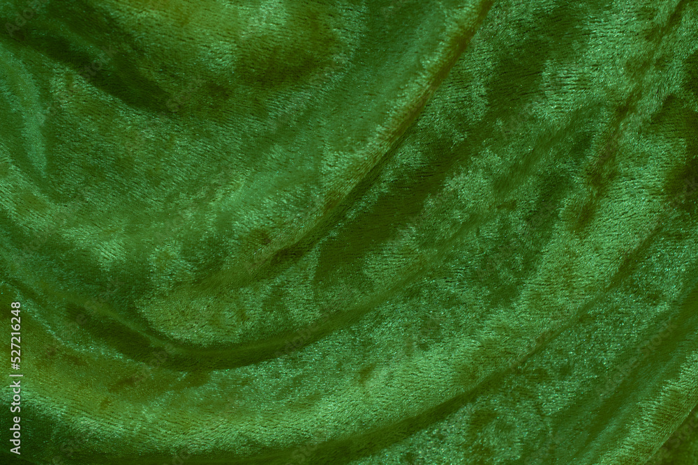Green velvet fabric surface from above. velvet texture green color