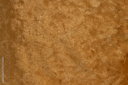 Gold velvet fabric surface from above. velvet texture gold color background. expensive luxury fabric, material, wallpaper.