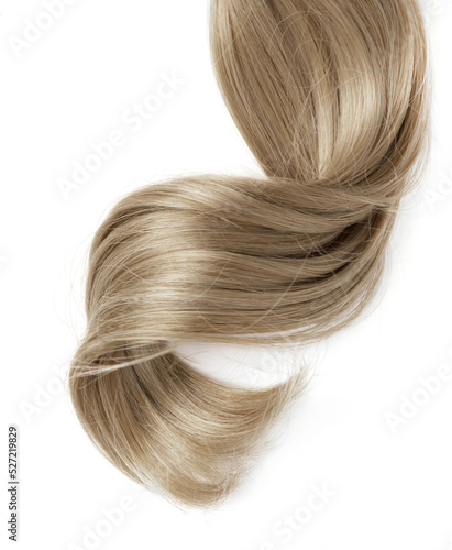 Long blond curly hair on white background. A part of blond hair for design.