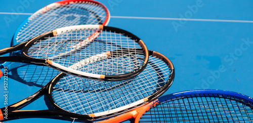 broken tennis rackets on clay tennis court © Angelov