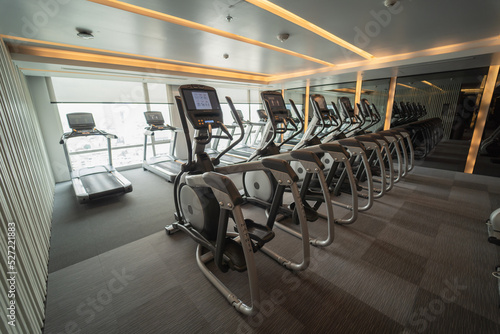 An indoor wellness fitness club with dumbbells and a treadmill to use for your workouts.