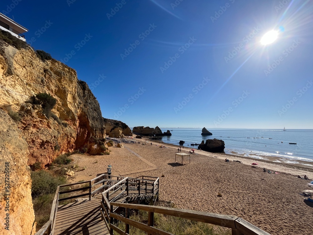 Naklejka premium Praia Dona Ana beach with turquoise sea water and cliffs, Portugal. Beautiful Dona Ana Beach (Praia Dona Ana) in Lagos, Algarve, Portugal Sunrise