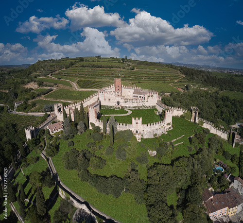 Soave castle aerial view Verona province, Italy. Ancient castle on a hill in Italy. View of Soave castle surrounded by vineyard plantations. photo
