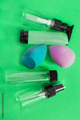 Cosmetic bottles on green