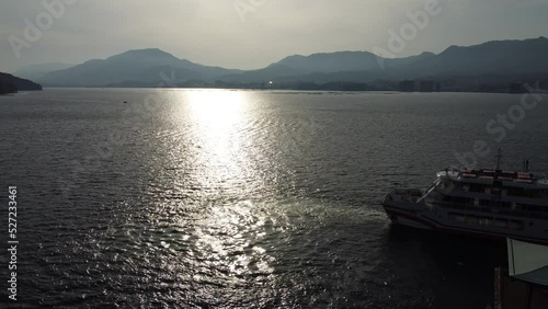 Sunset over a ship waiting to depart from the port of Miyajima, Hiroshima, Japan