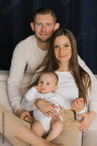 Cute stylish family dad, mom and baby boy are happy to be together