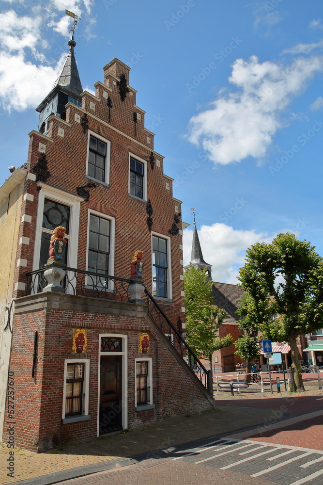 The external facade of the Raadhuis (former town hall built in 1615) in Balk, Friesland, Netherlands, located in the historic center of Balk along a canal