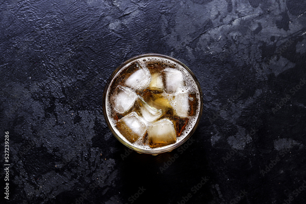 Glass with lemonade and ice. Top view. Copy space. A glass of beer on a dark concrete background. Glass with lemonade and ice. Top view. Copy space. A glass of beer on a dark concrete background.