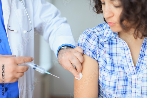 Doctor with vaccine syringe with patient