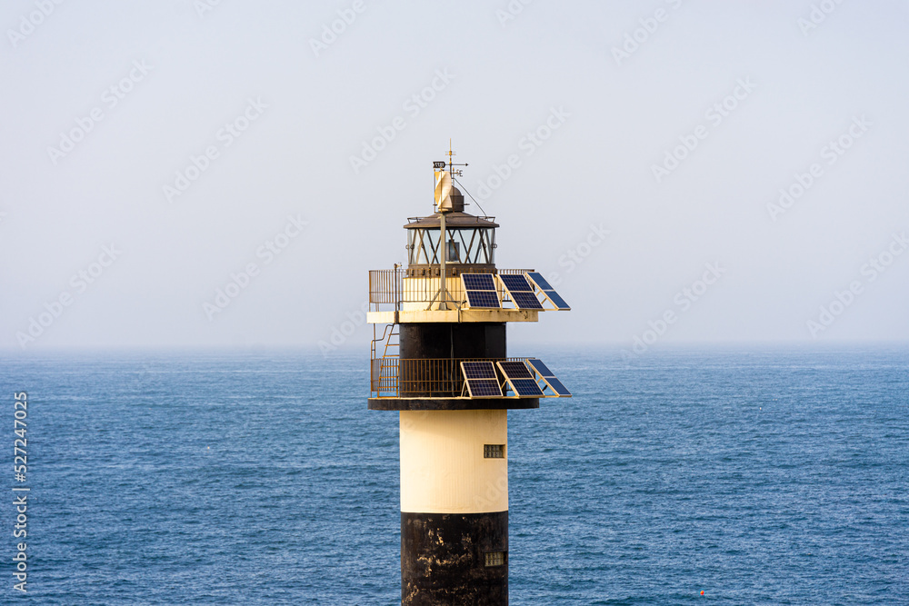 black and withe lighthouse with solar panels