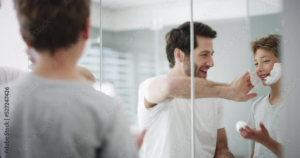 Learning, teaching and family bathroom of a father and son playing with shaving face cream. Mirror reflection of a happy child and parent relax and content at morning play with foam together at home Learning, teaching and family bathroom of a father and son playing with shaving face cream. Mirror reflection of a happy child and parent relax and content at morning play with foam together at home