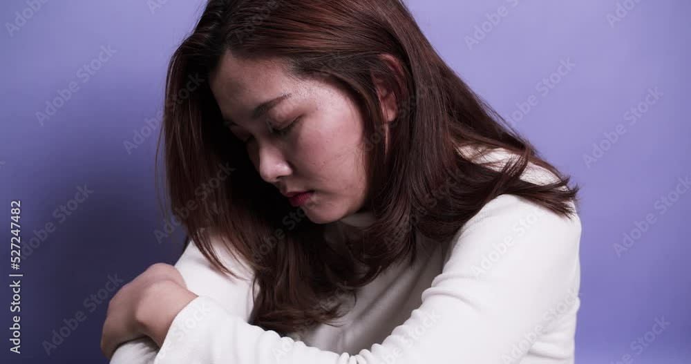 Woman portrait with problem of depression emotion sad alone on purple background Woman portrait with problem of depression emotion sad alone on purple background