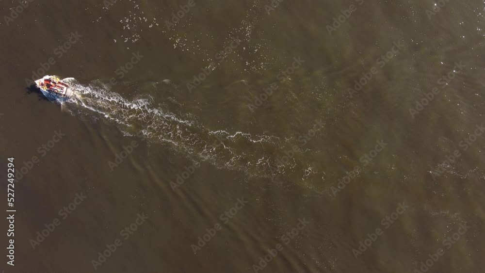 aerial shot of a Fishing boat on the uruguayan coast in the atlantic ocean_top down view aerial shot of a Fishing boat on the uruguayan coast in the atlantic ocean_top down view