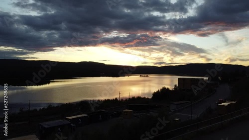 Flying through trees to leave  a fantastic sunset over a lake in Norway photo