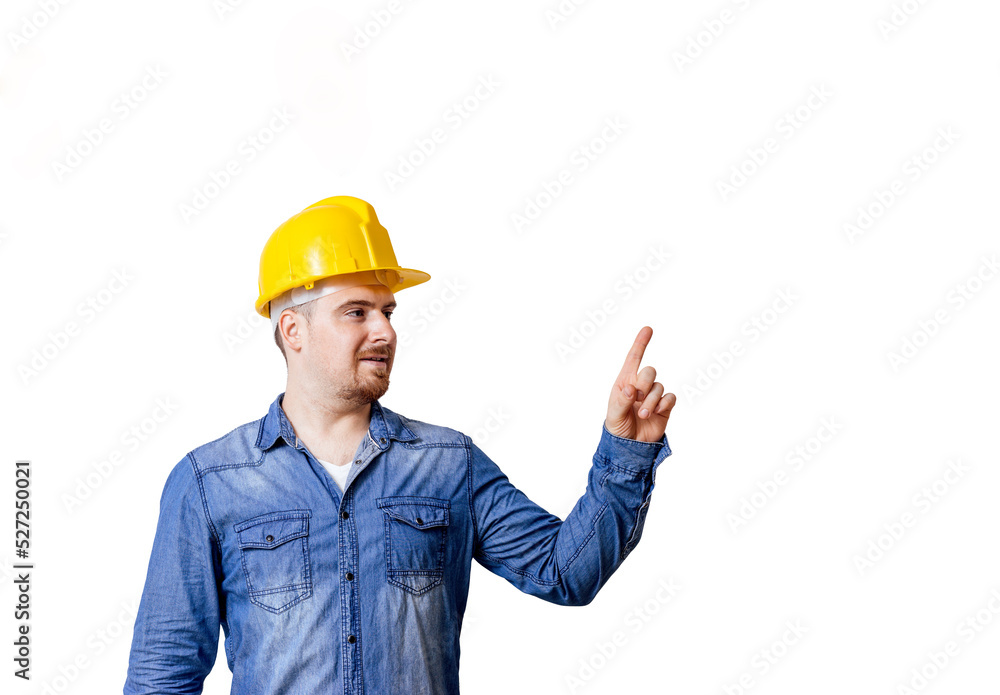 Young man with safety helmet is pointing to a copy space.