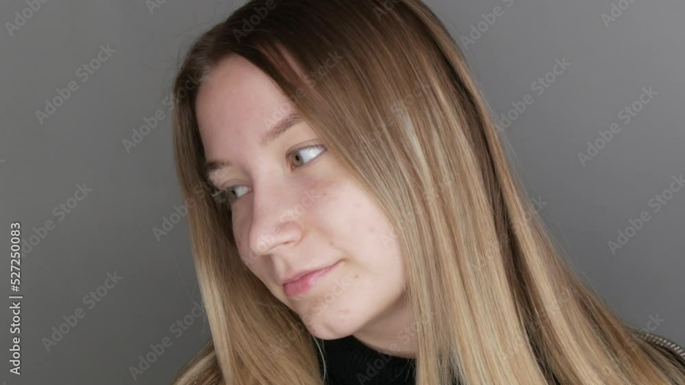Beautiful young girl without makeup with a natural appearance posing in front of the camera in the studio Beautiful young girl without makeup with a natural appearance posing in front of the camera in the studio