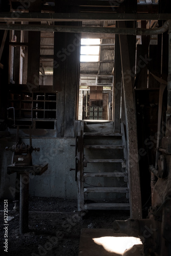 light filtering through window and down stairs in unused shearing quarters photo
