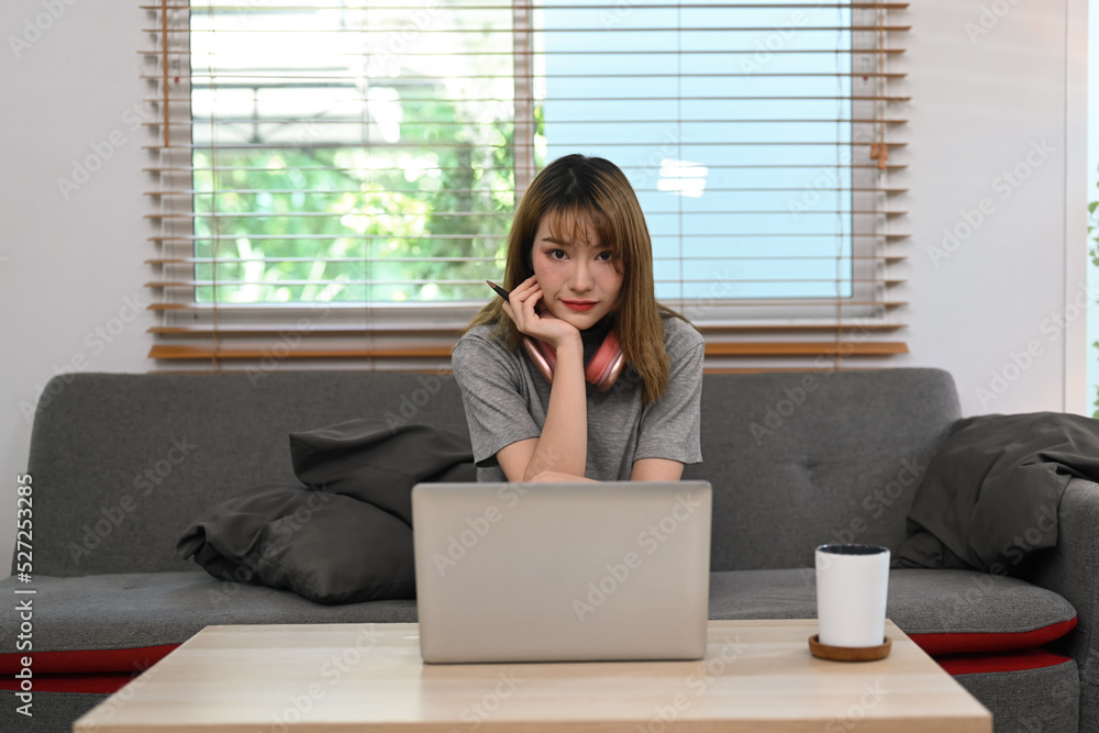 Pretty young woman using laptop for checking email or working online from home Pretty young woman using laptop for checking email or working online from home