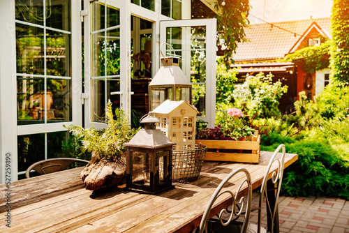 wooden table in the courtyard of the country house with retro decor elements.