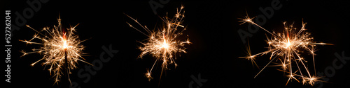 Set of sparklers on black background. Wide panoramic design of Christmas sparkler lights.
