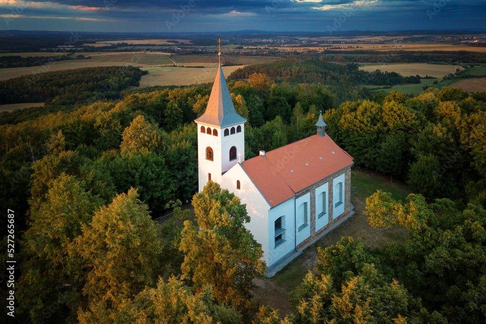Church with a lookout tower at sunset photo from a drone