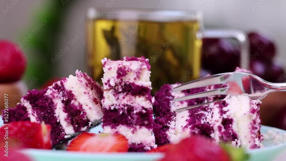 Take with a fork a red and white cake with cheese cream, a sweet dessert with strawberry berry flavor Take with a fork a red and white cake with cheese cream, a sweet dessert with strawberry berry flavor