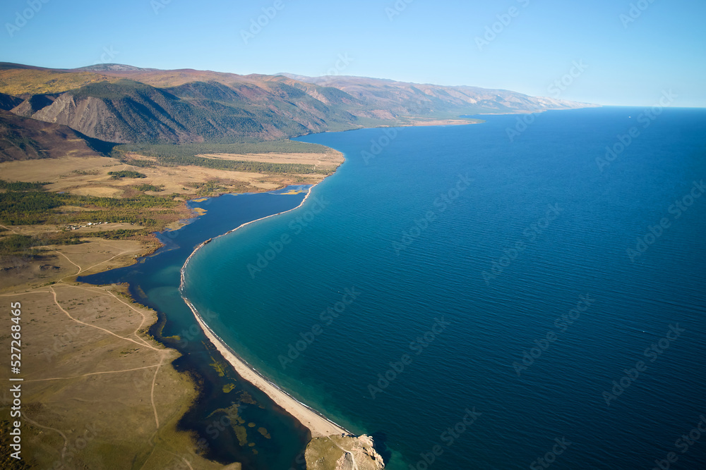 Lake Baikal from the air. View of the bay, mountains.
