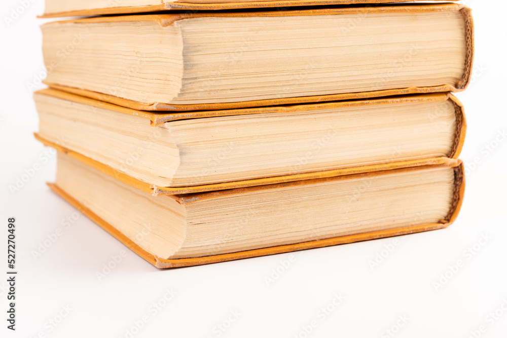 Stack of old books on light background. Book pile. Stack of old books on light background. Book pile.