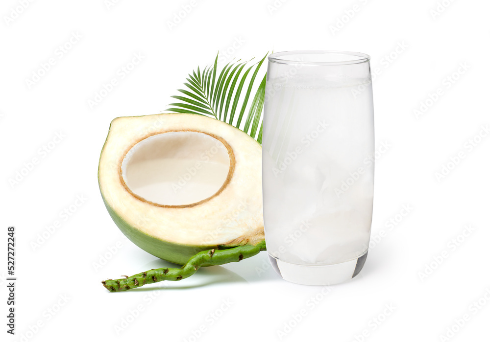Glass of coconut water with coconut juice in half fruit and palm leaf isolated on white background. Glass of coconut water with coconut juice in half fruit and palm leaf isolated on white background.