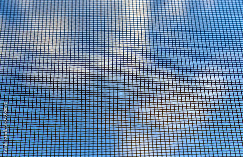 Background of blue sky through fine mosquito net.