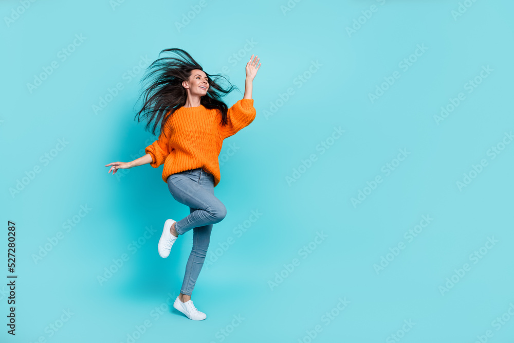 Full length portrait of pretty positive person enjoy free time dance look empty space isolated on teal color background