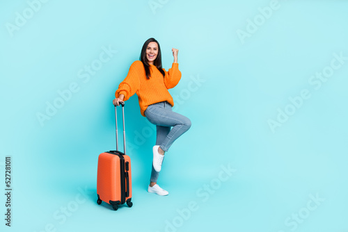 Full body portrait of delighted positive lady raise fist triumph attainment isolated on emerald color background