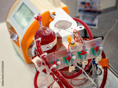 Medical equipment. Medical device close-up. Modern medical equipment on table. Tubes and vials with red liquid next to device. Med technology. Equipment for field clinic laboratory. photo