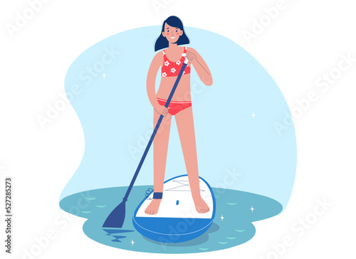Standing woman is paddling with paddle board on the water. Woman in water on sup board. SUP surfing concept.