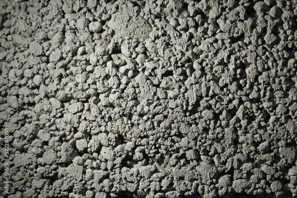 close up of a gray foam concrete building block. grey textured background close up of a gray foam concrete building block. grey textured background