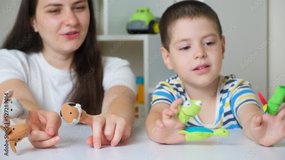 Mother and son play finger theater, toys on fingers. Mother and son play finger theater, toys on fingers.