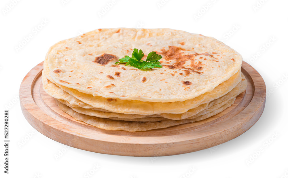 Chapati tortillas with fresh parsley are isolated in close-up on a white background. Traditional Indian flatbreads. Side view