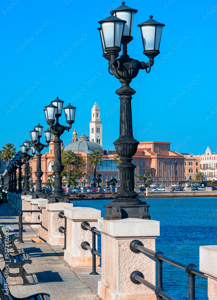 tourists on the seafront of Bari, the capital of Puglia in southern Italy.