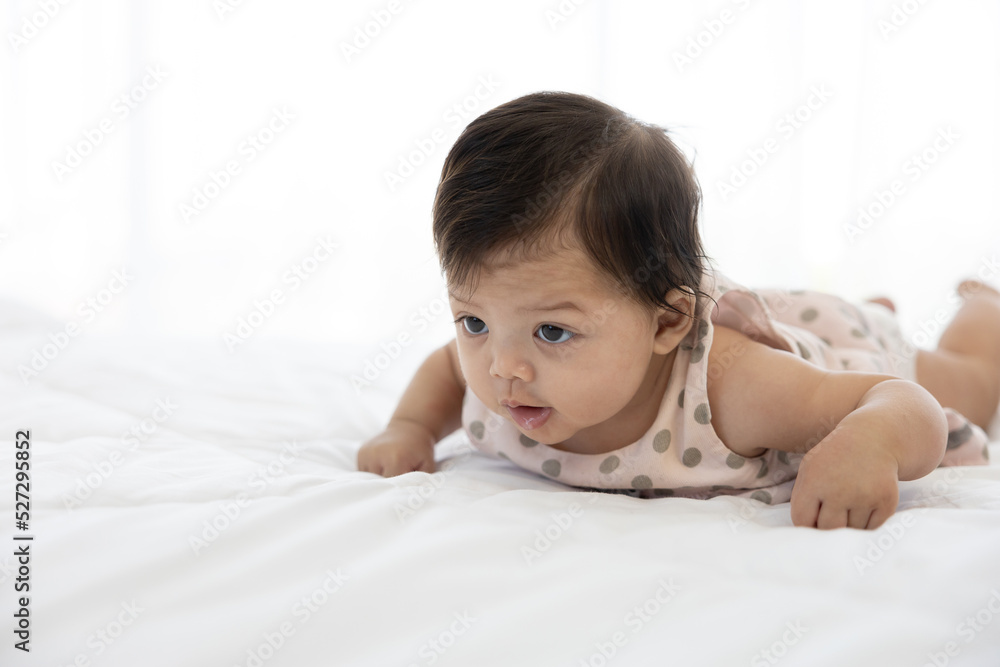 portrait cute baby crawling on bed and looking to something portrait cute baby crawling on bed and looking to something
