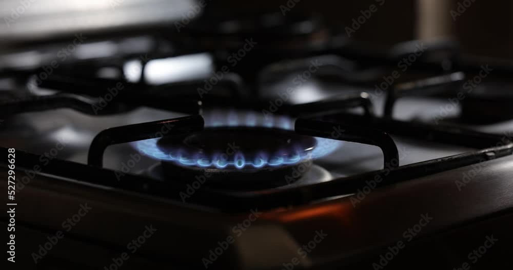 Burner stove igniting into a blue cooking flame in 4K UHD. Burner stove igniting into a blue cooking flame in 4K UHD.