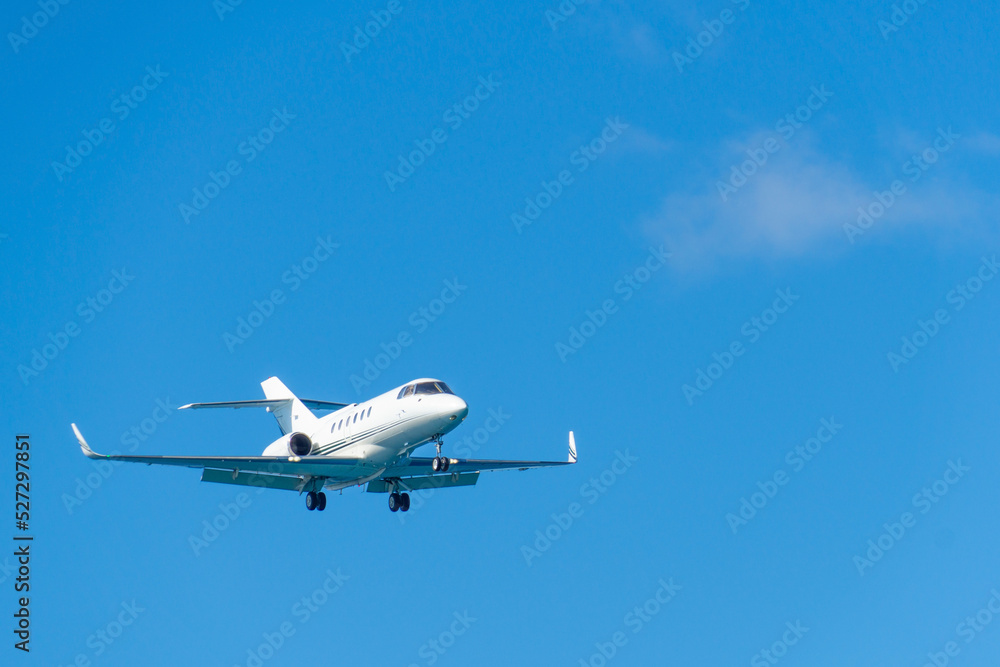 Blurred business jet in clear blue sky. Private jet in flight. Blurred business jet in clear blue sky. Private jet in flight.